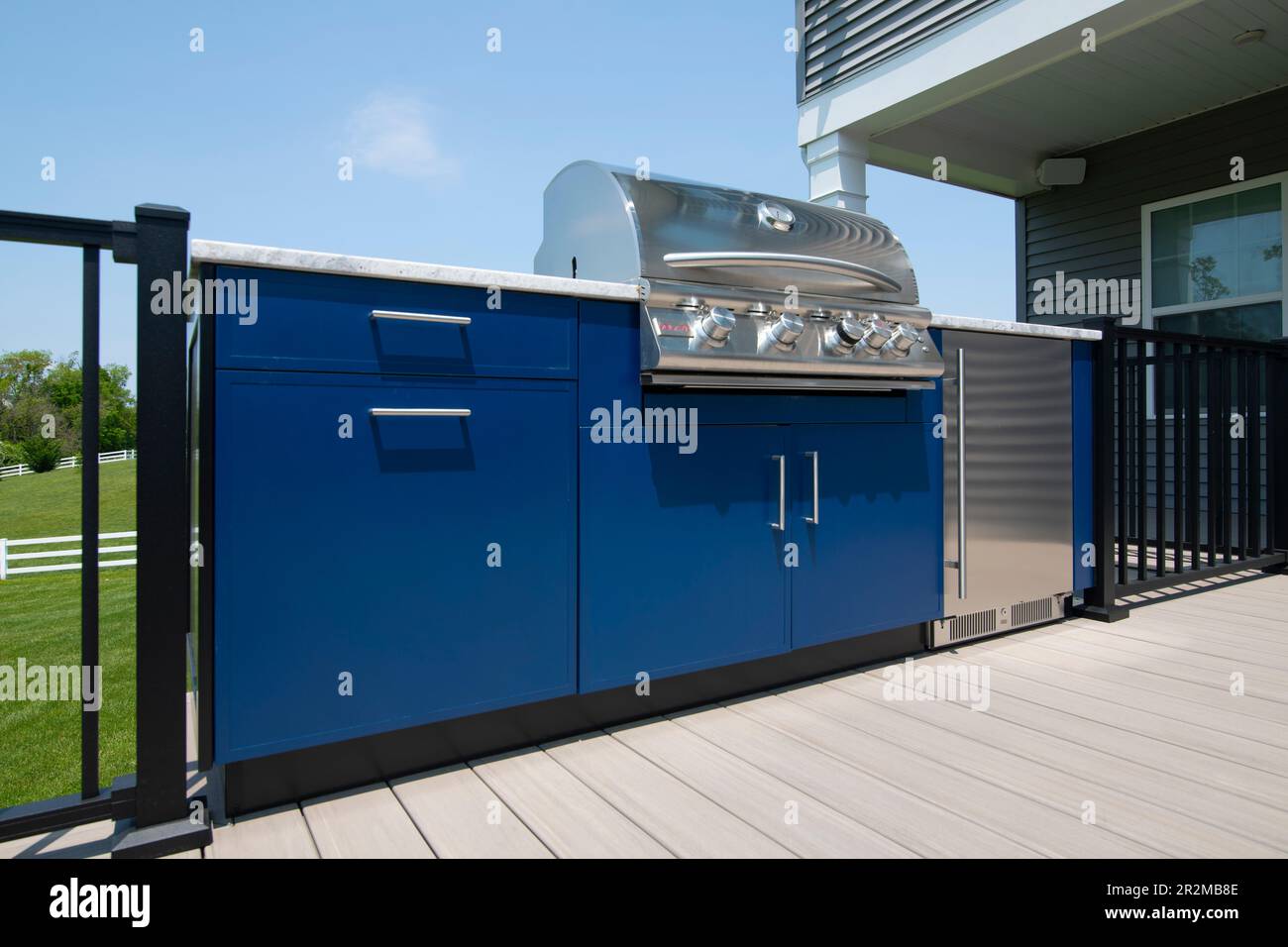 An outdoor gas grill kitchen with a refrigerator on a backyard deck in Maryland USA Stock Photo