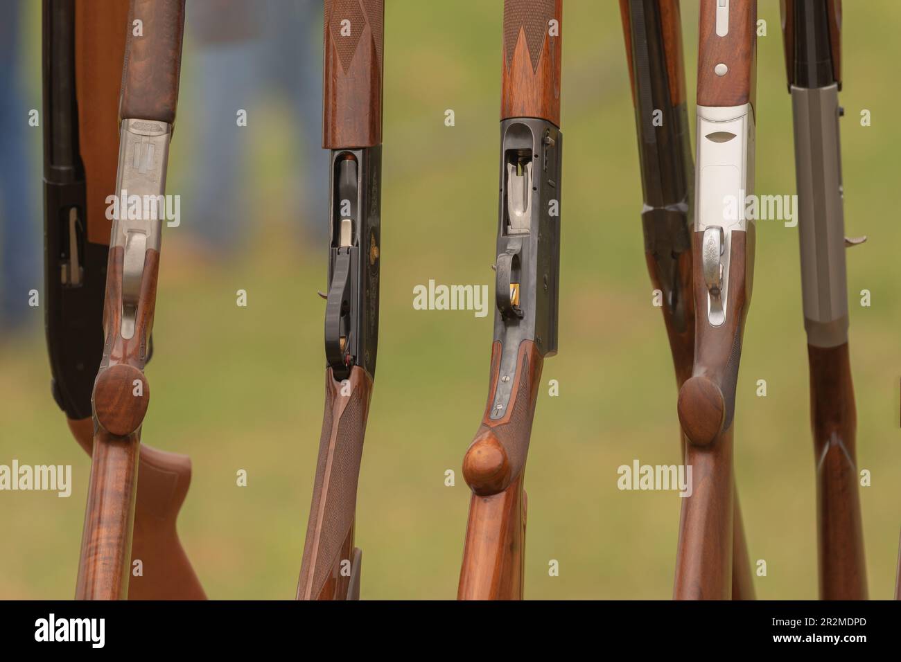 Shotguns are lined up on a rack waiting for a shooter to take their ...