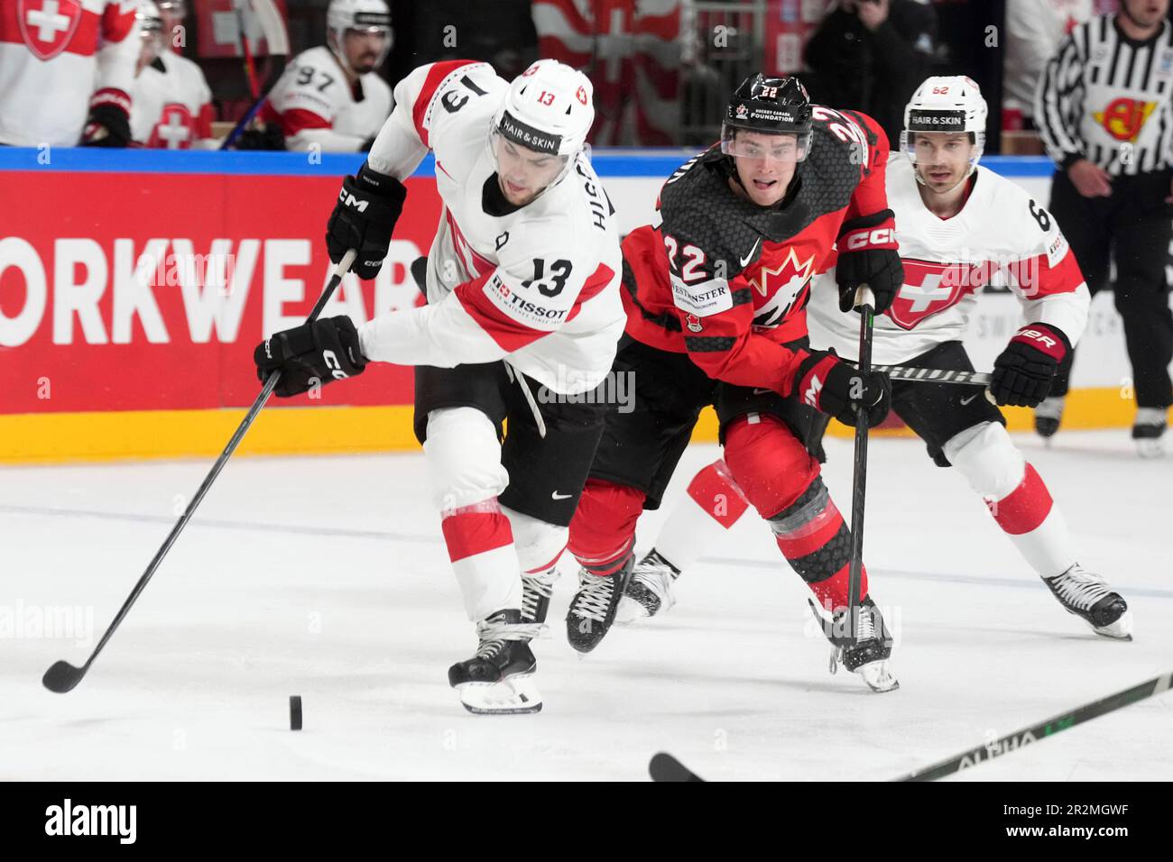 Nico Hischier of Switzerland, left, fights for a puck with goalie Samuel  Montembeault of Canada during the group B match between Switzerland and  Canada at the ice hockey world championship in Riga