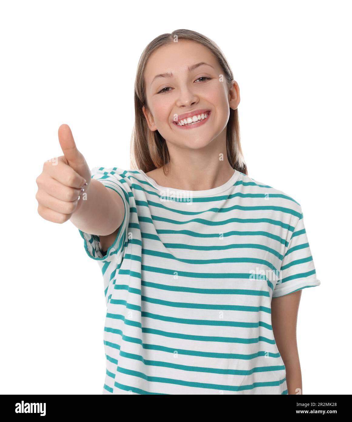 Teenage girl showing thumb up on white background Stock Photo - Alamy