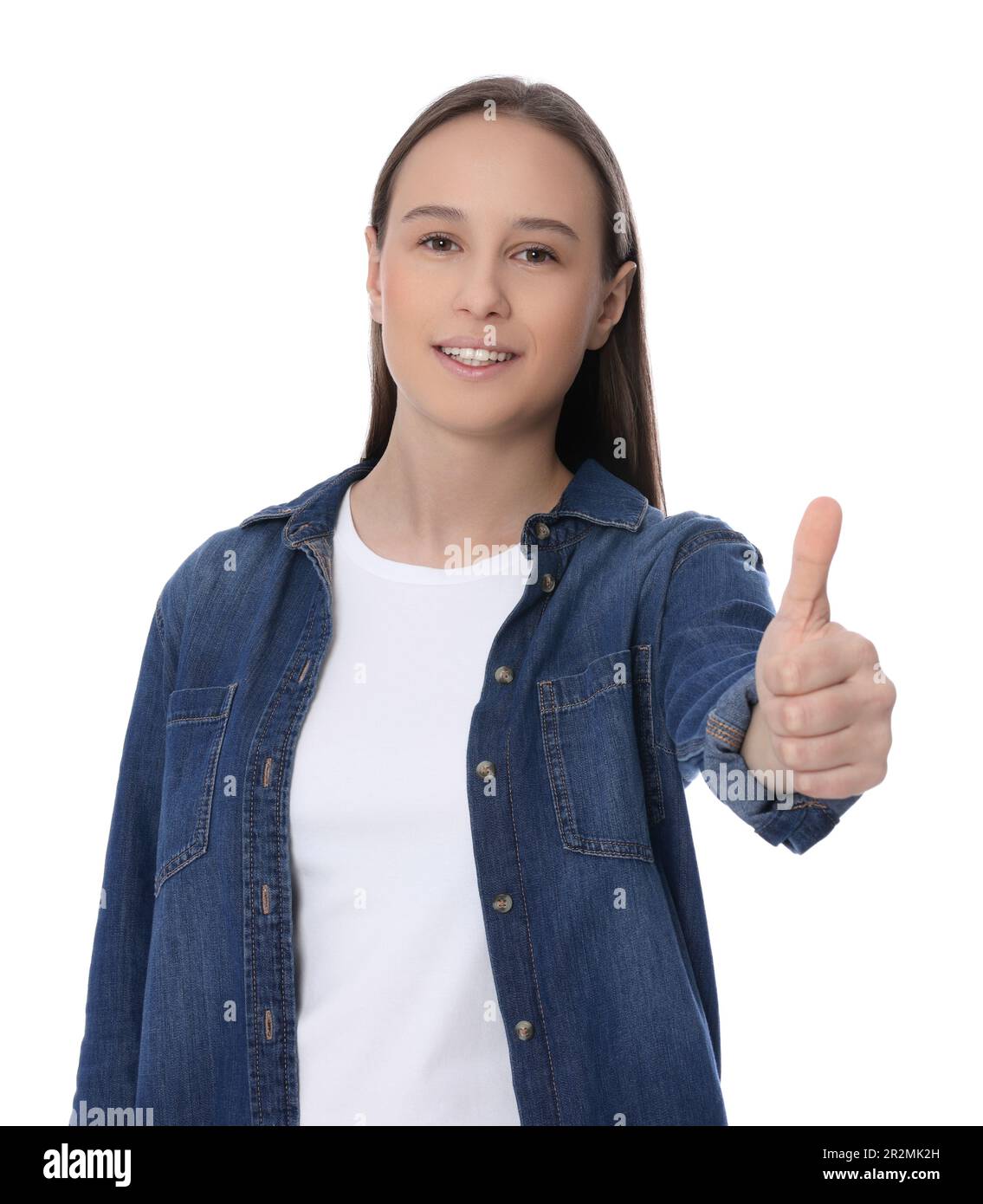 Teenage girl showing thumb up on white background Stock Photo - Alamy