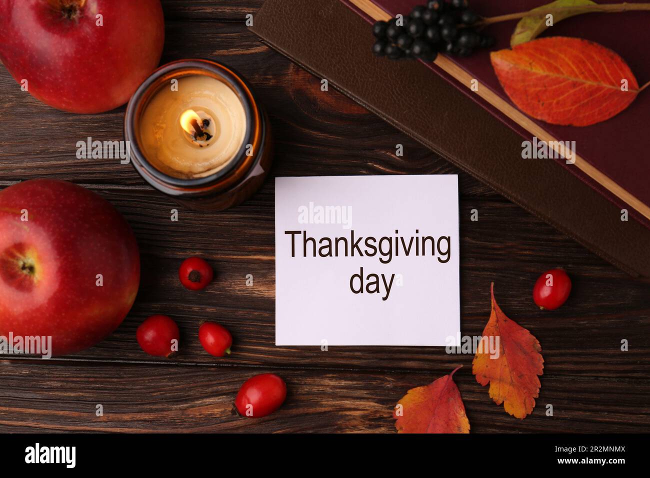 Thanksgiving Day. Flat lay composition with paper card and autumn leaves on wooden table Stock Photo