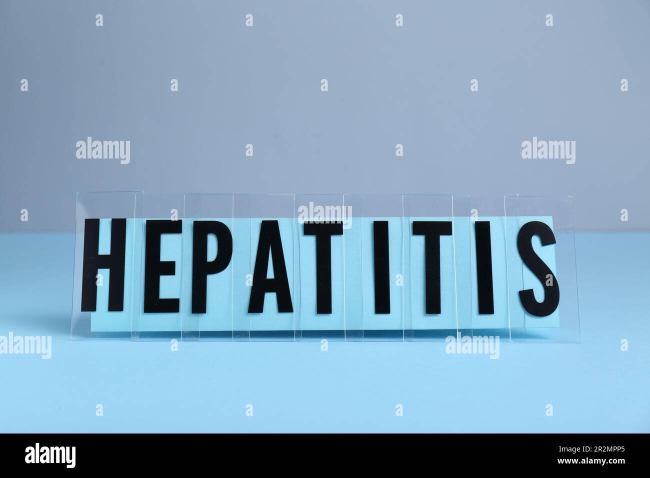 Word Hepatitis on light blue table. Medical issue Stock Photo - Alamy