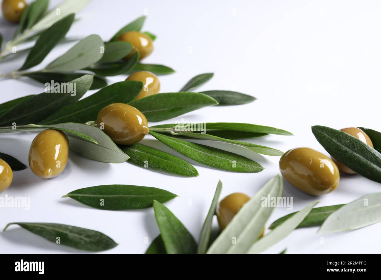 Fresh green olives and leaves on white background Stock Photo - Alamy