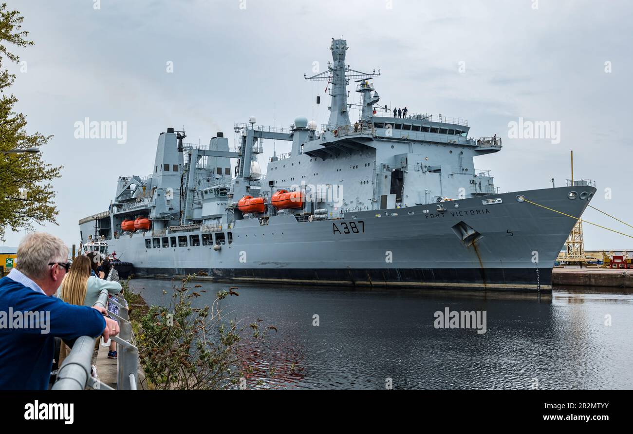 Edinburgh, Scotland, UK, 20th May 2023. RFA Fort Victoria (A387) enters Leith harbour: the combined fleet stores ship and tanker of the Royal Fleet Auxiliary of the United Kingdom tasked with providing ammunition, fuel, food and other supplies to British Royal Navy vessels is manoeuvred into the harbour to a mooring by tug boats. Credit: Sally Anderson/Alamy Live News Stock Photo