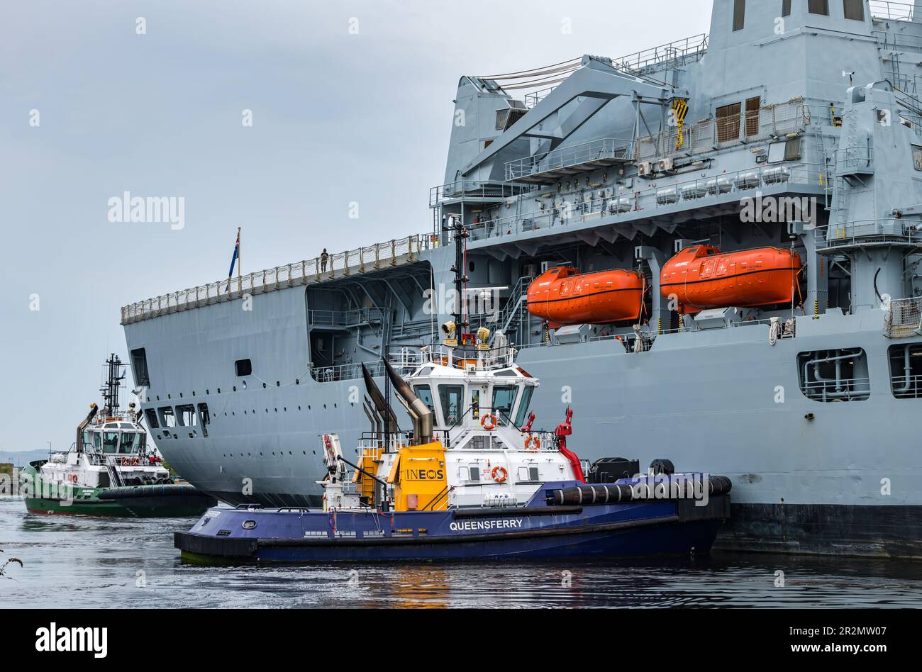 Edinburgh, Scotland, UK, 20th May 2023. RFA Fort Victoria (A387) enters Leith harbour: the combined fleet stores ship and tanker of the Royal Fleet Auxiliary of the United Kingdom tasked with providing ammunition, fuel, food and other supplies to British Royal Navy vessels is manoeuvred into the harbour to a mooring by tug boats. Credit: Sally Anderson/Alamy Live News Stock Photo