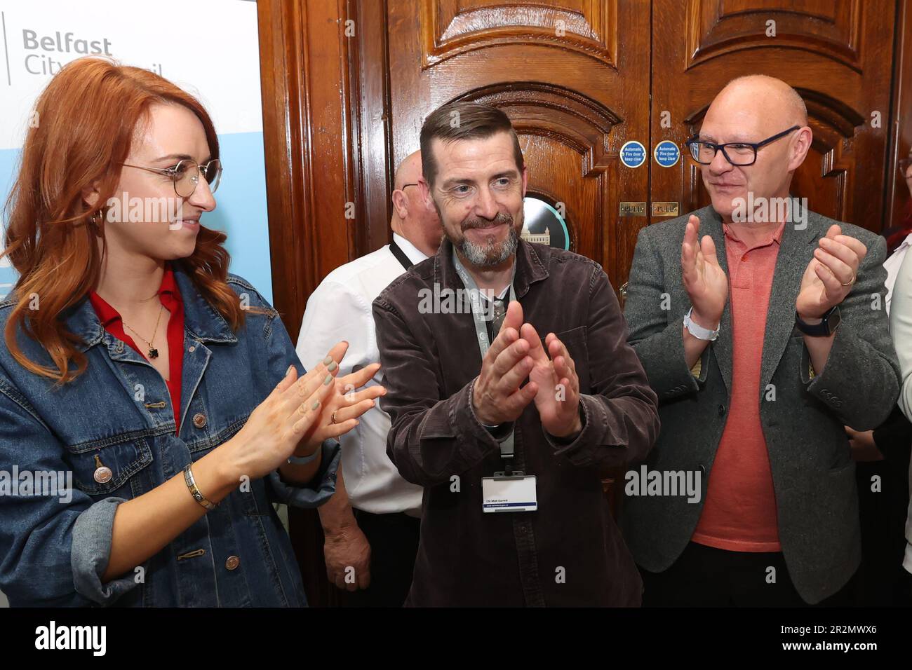 Sinn Fein's Matt Garrett (centre) celebrates with colleagues Paul Maskey MP (right) and Cliodhna Nic Bhranair (left) after winning a seat in Collin, in the Northern Ireland council elections at Belfast City Hall. Picture date: Saturday May 20, 2023. Stock Photo