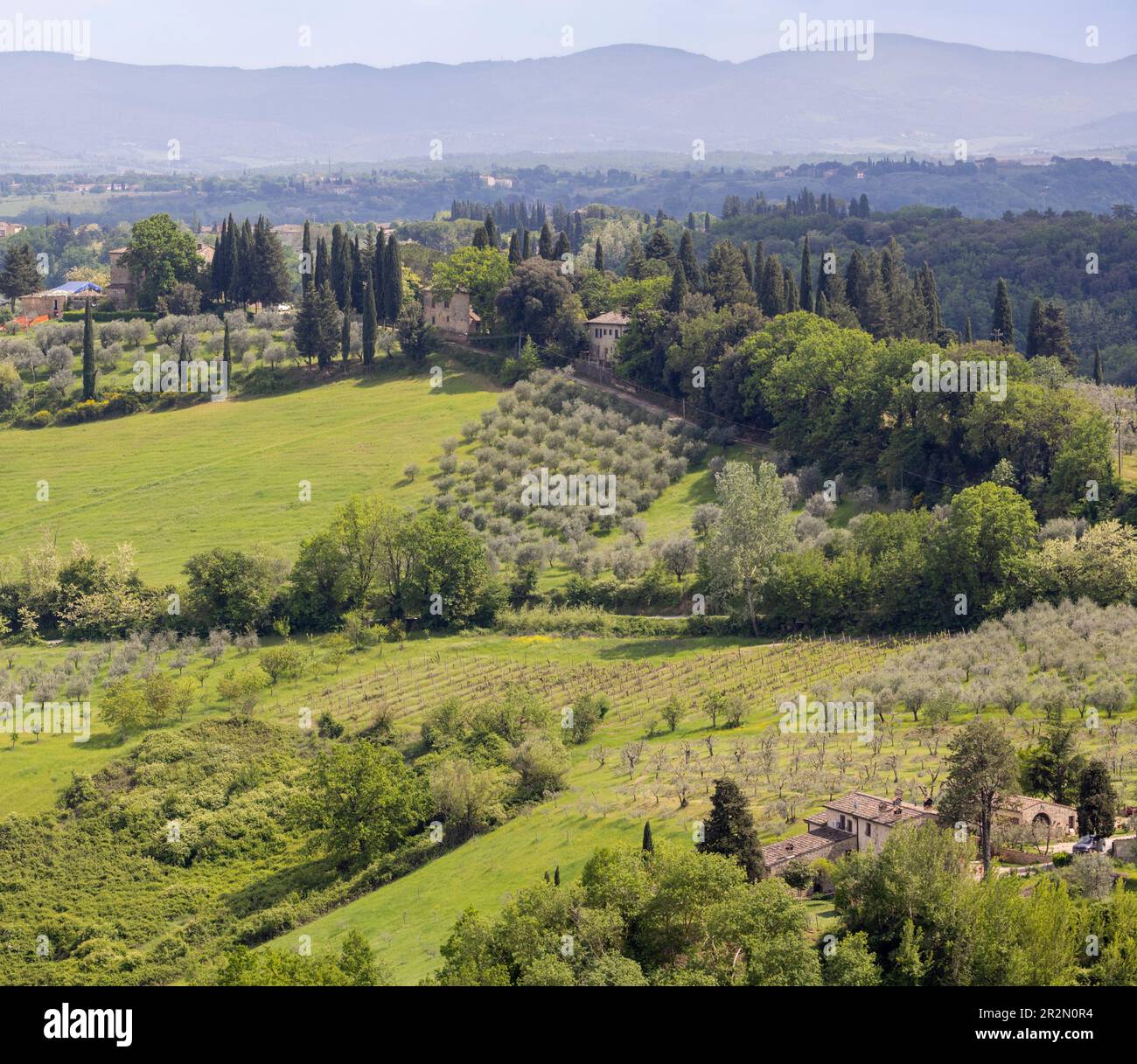 Countryside and farm houses surrounding San Gimignano, Siena Province, Tuscany, Italy.   San Gimignano is a UNESCO World Heritage Site. Stock Photo