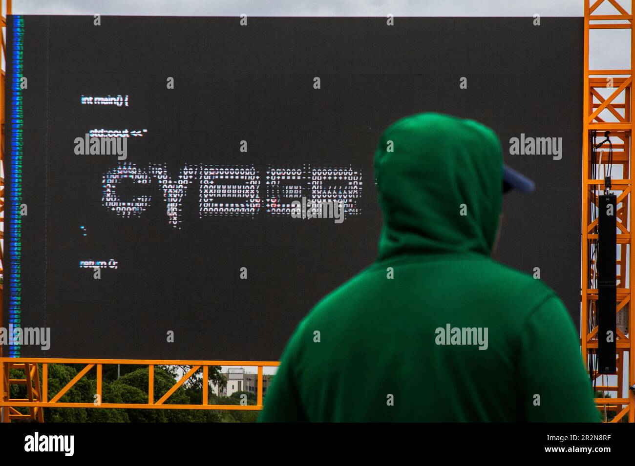 Moscow, Russia. 20th of May, 2023. A man is watching a street media board of the Positive Hack Days cyber festival in Gorky Park in Moscow, Russia Stock Photo