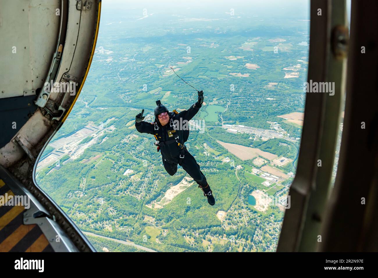 SSG Nahu Ramirez waving as he jumps from the US Army Golden Knights' plane at the Westfield International Airshow. Stock Photo