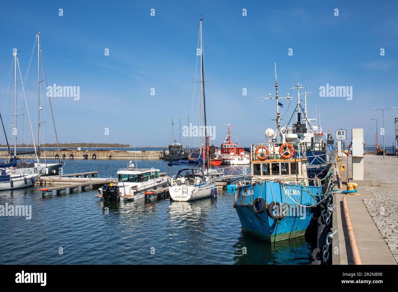 Fishing vessel Vilma and other moored boats at Lennusadam quayside on a sunny late spring day in Kalamaja district of Tallinn, Estonia Stock Photo