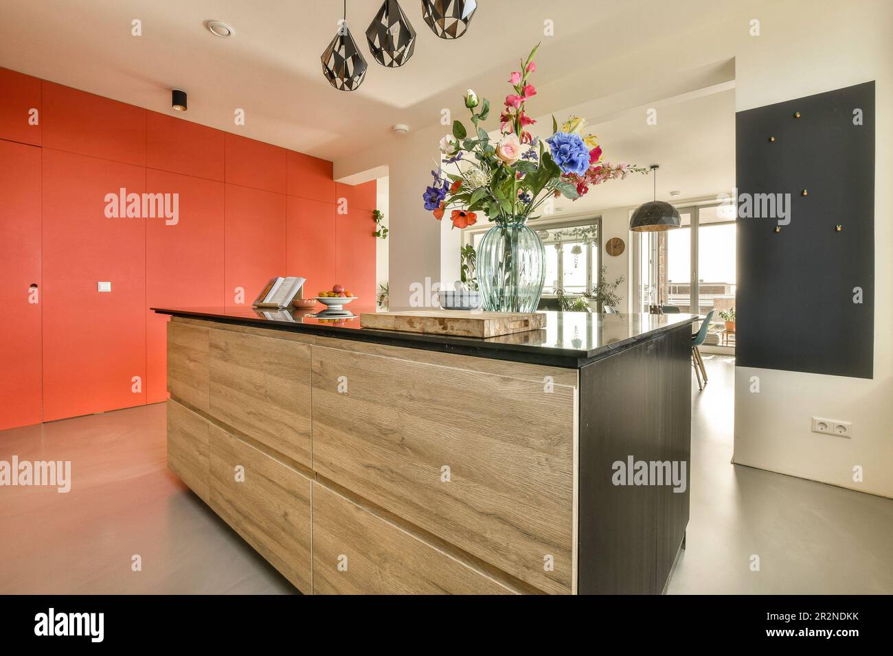 some flowers in a vase on the front of a reception desk with an orange ...