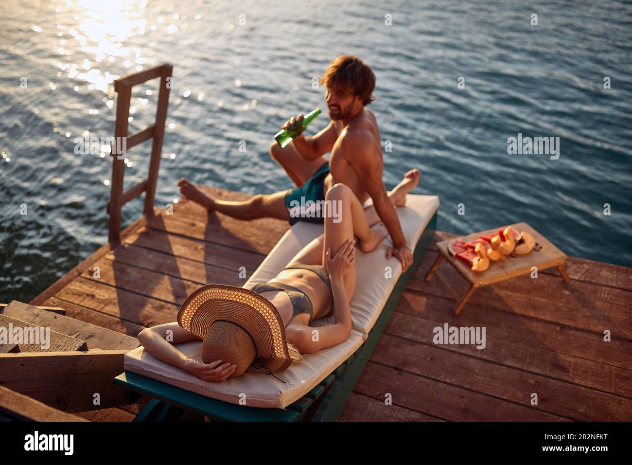 a-bird-s-eye-view-on-a-young-couple-in-swimsuit-chatting-and-sunbathing