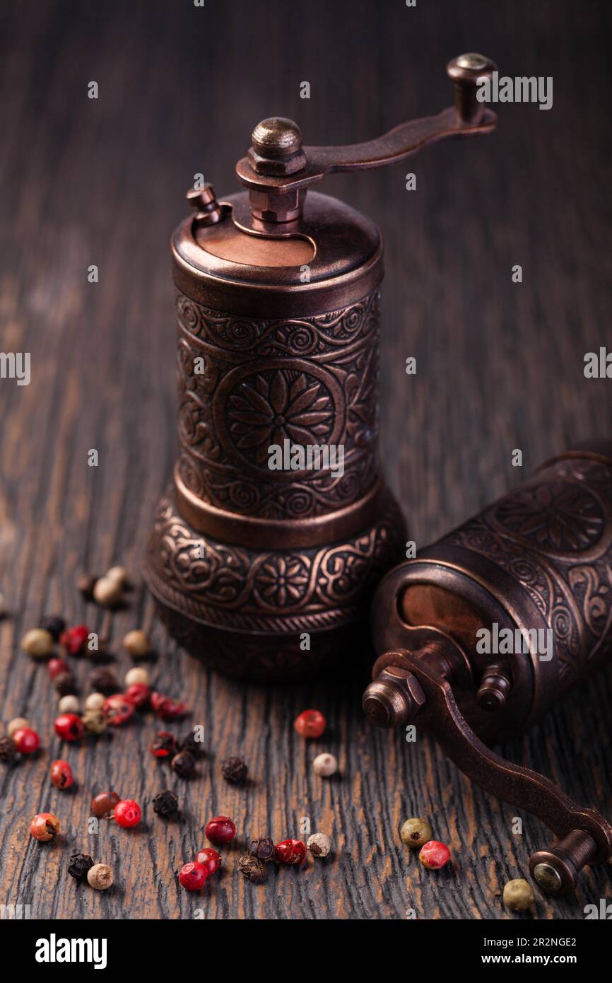 pepper grinders on a wooden table Stock Photo