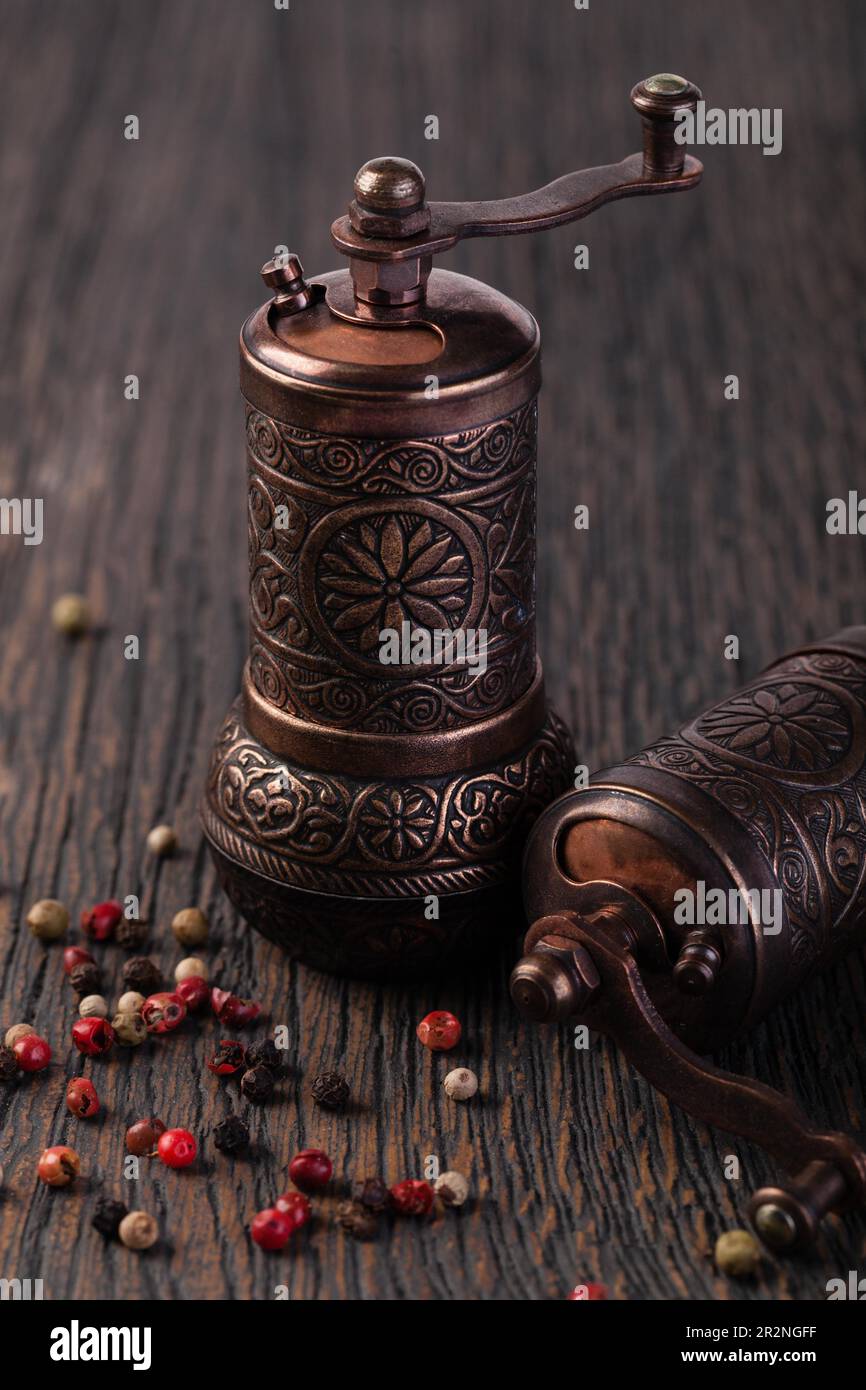 pepper grinders on a wooden table Stock Photo