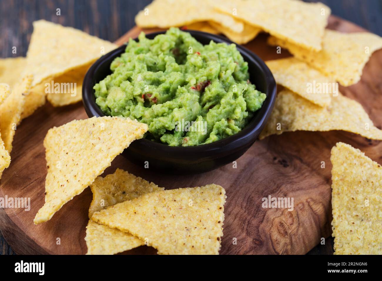 Corn chips nachos with sauce on a wooden table Stock Photo
