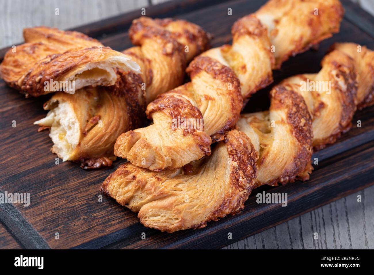 Cheese filled roll on a wooden Stock Photo
