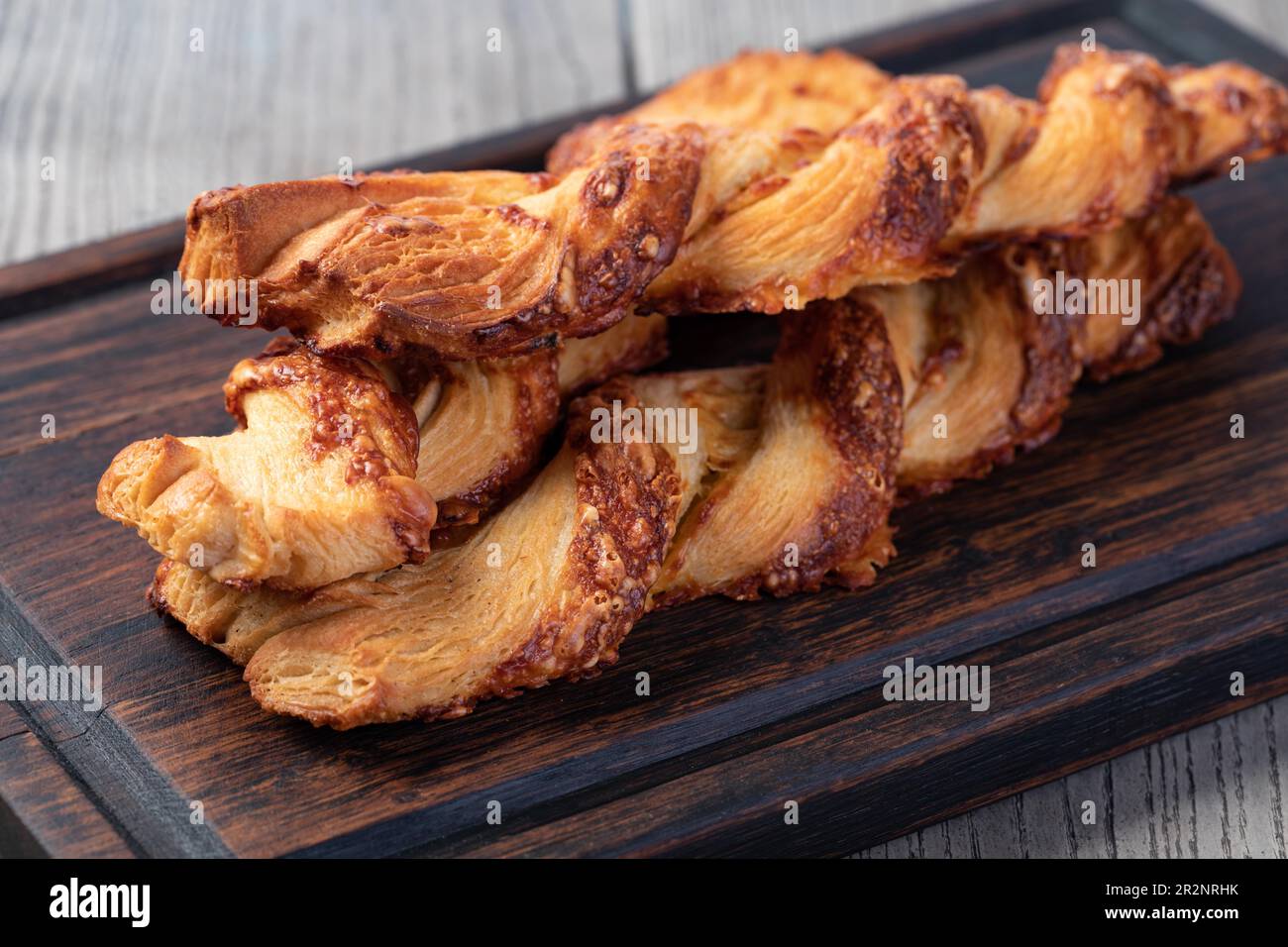 Cheese filled roll on a wooden Stock Photo