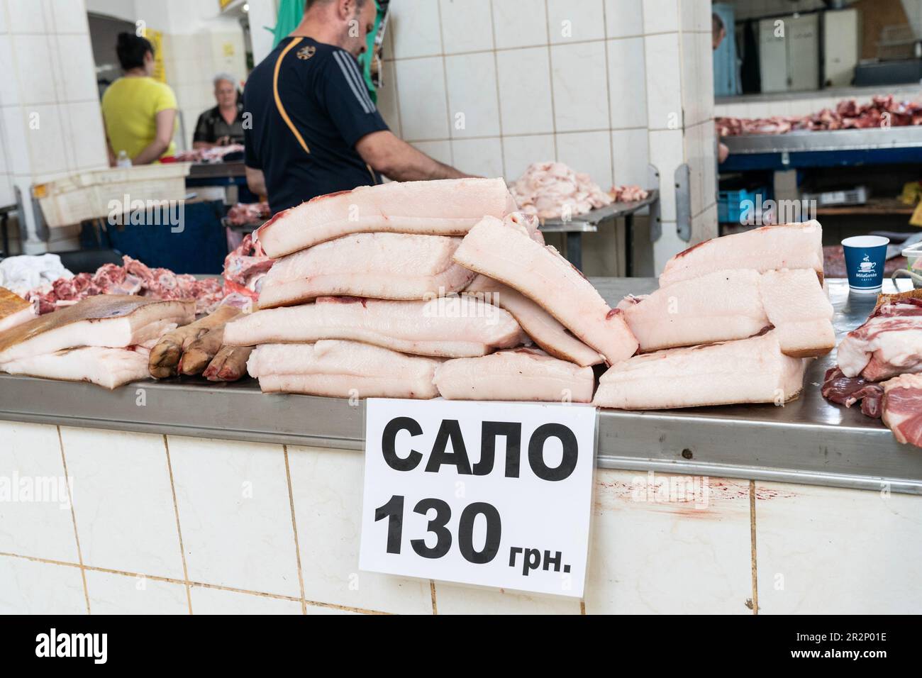 Vendor is selling pork fat and meat on famous farmer market Pryvoz established in 1827 in Odesa, Ukraine on May 20, 2023 Stock Photo