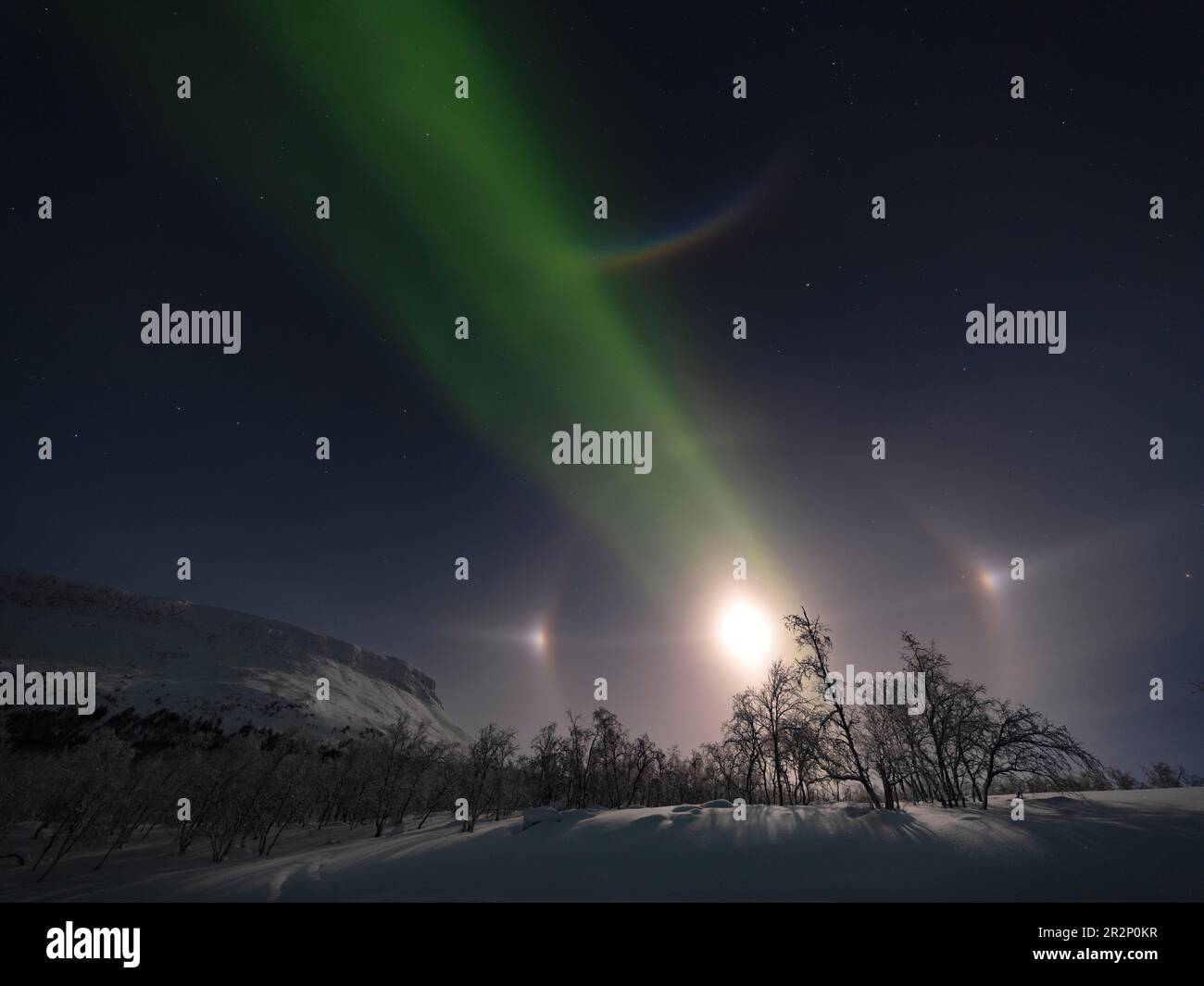 Northern Lights with Moon Halo, Moon-dogs, the Big Dipper and Polaris next to Saana, a sacred Sami mountain Stock Photo