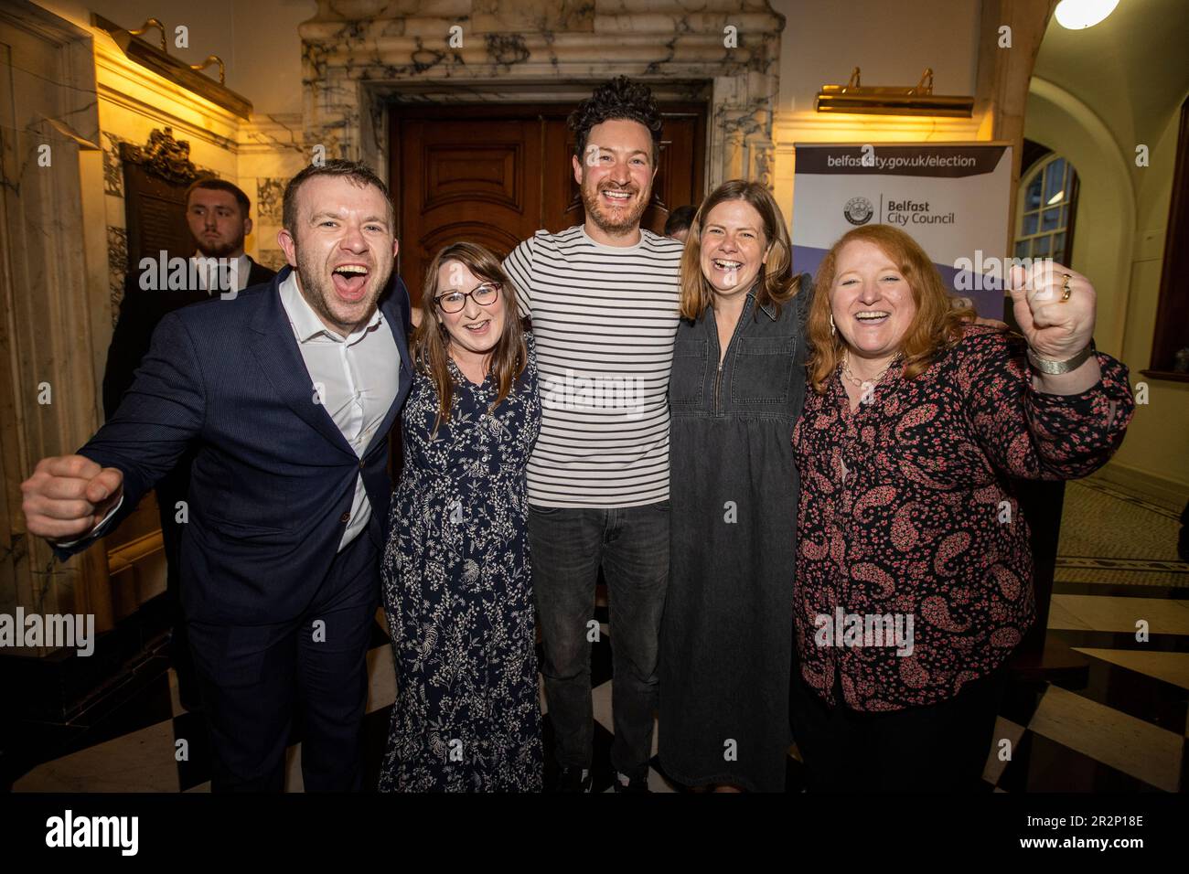 Alliance party’s Ross McMullan (centre) celebrates winning a seat in Ormiston with party colleagues Peter McReynolds MLA (left), Christine Bower (second from left), Jenna Maghie (second from right), and party leader Naomi Long MLA (right) at Belfast City Hall during the Northern Ireland council elections. Picture date: Saturday May 20, 2023. Stock Photo