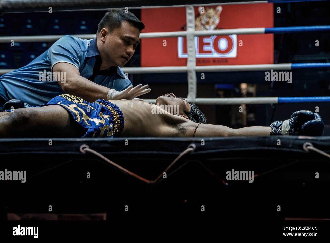 A referee seen counting out after a Muay Thai boxer is knocked down, at Bangkok's Rajadamnern stadium. Muay Thai fights at Thailand’s iconic boxing Rajadamnern stadium, the dream stage for competitors and it is favourite for combat sports all over the world. Stock Photo