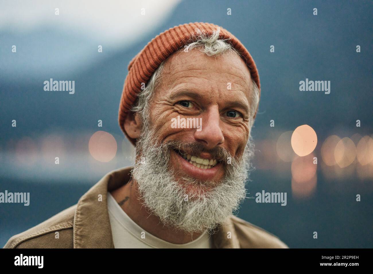 Happy active older man traveler standing in nature park. Close up portrait Stock Photo