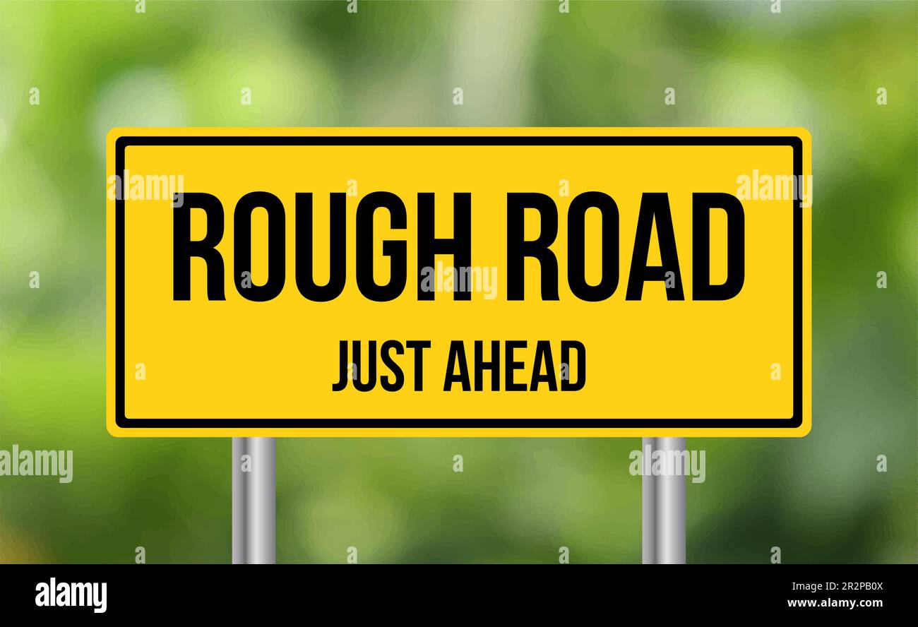 Rough Road just ahead road sign on blur background Stock Photo