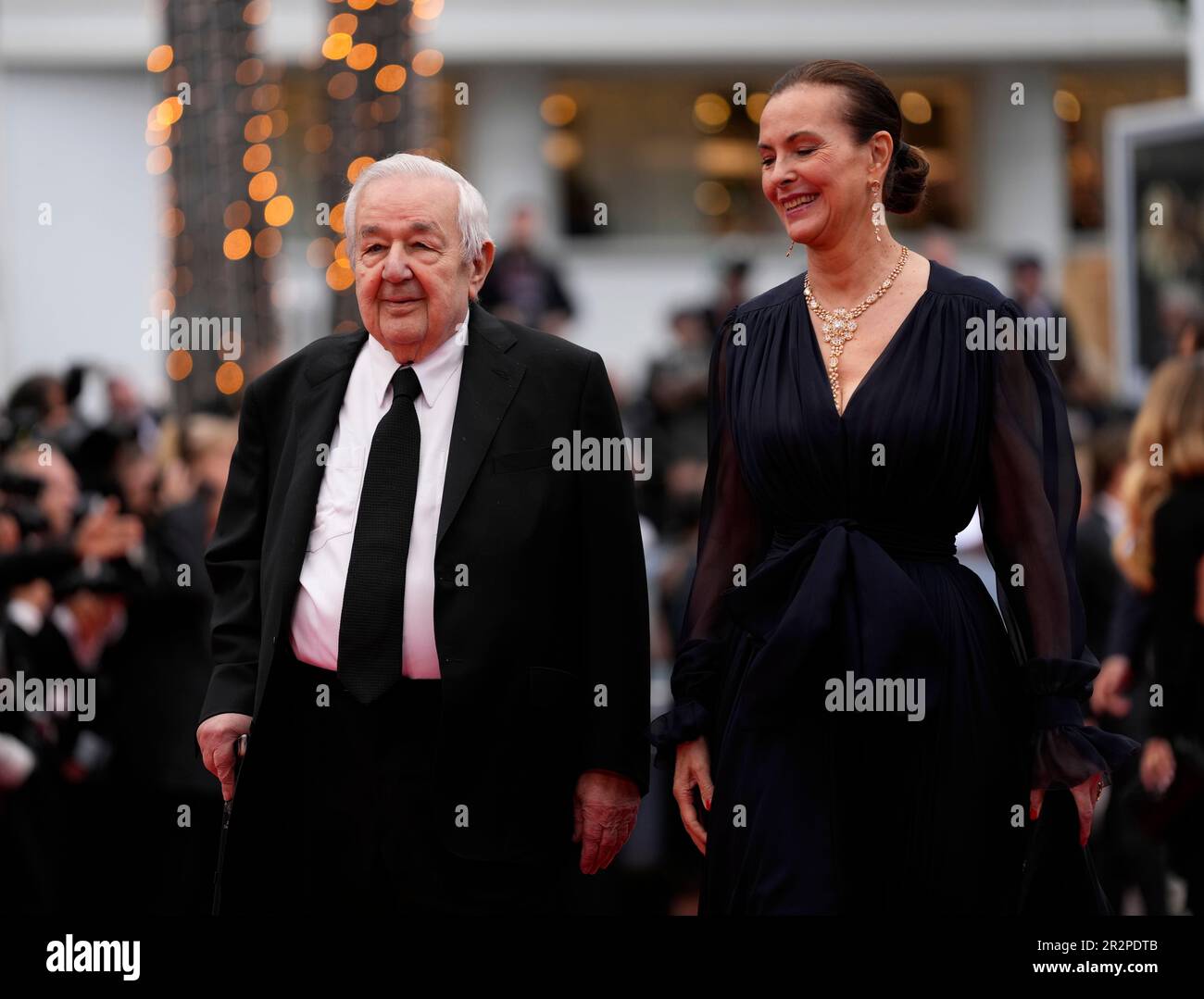 Paul Rassam, from left, and Carole Bouquet pose for photographers upon