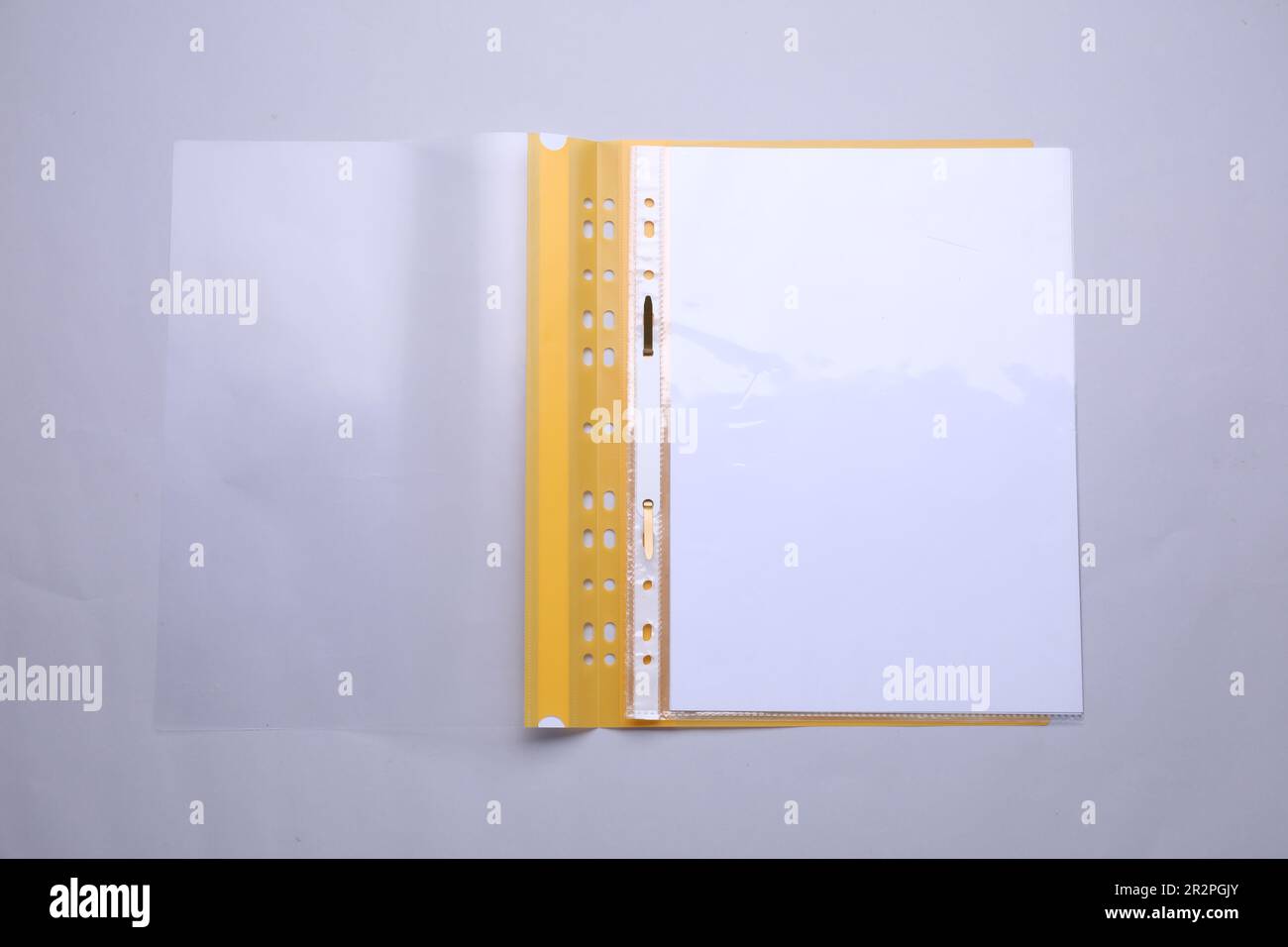 File folder with punched pockets and paper sheets on light grey background, top view Stock Photo