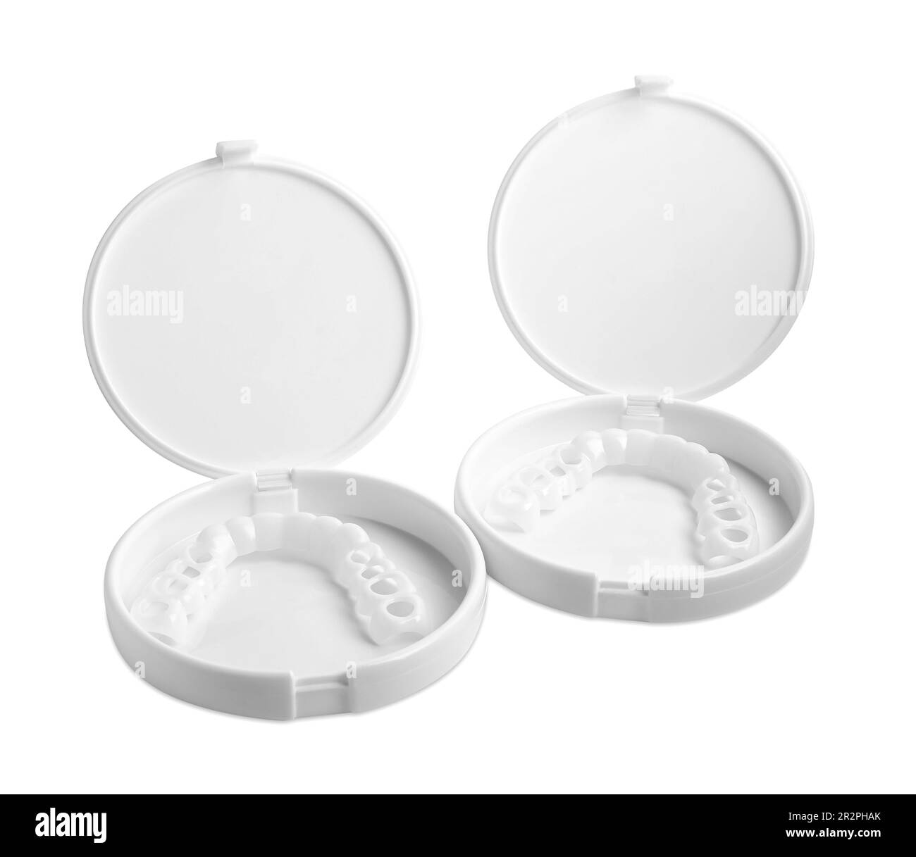 Containers with dental mouth guards on white background. Bite