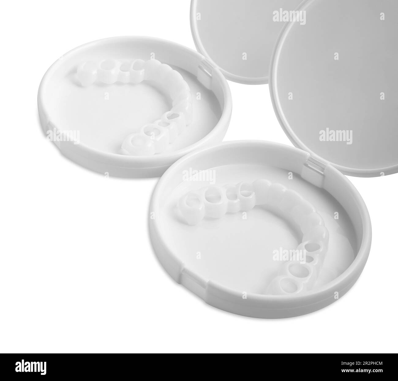Containers with dental mouth guards on white background. Bite