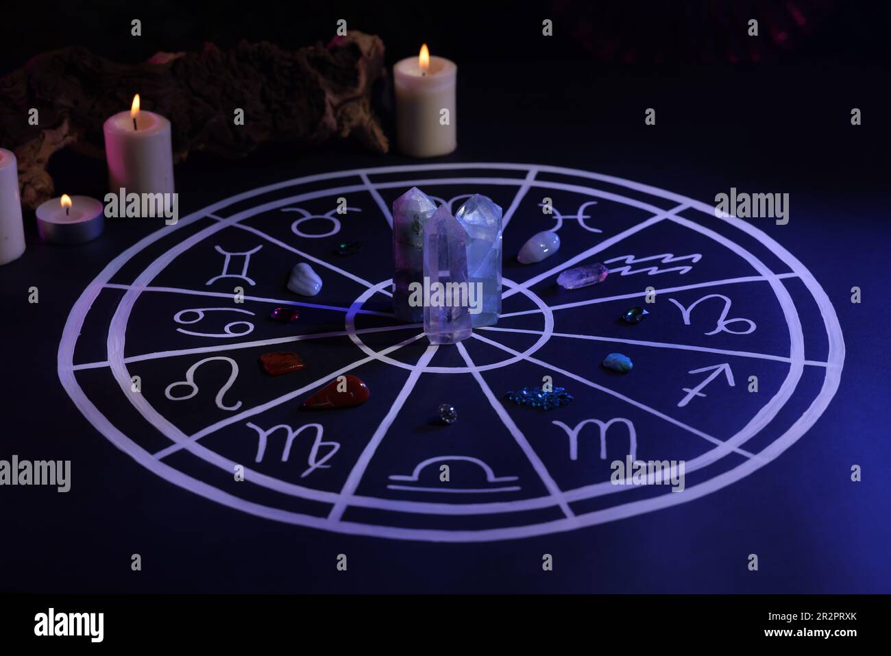 Natural stones for zodiac signs, drawn astrology chart and burning