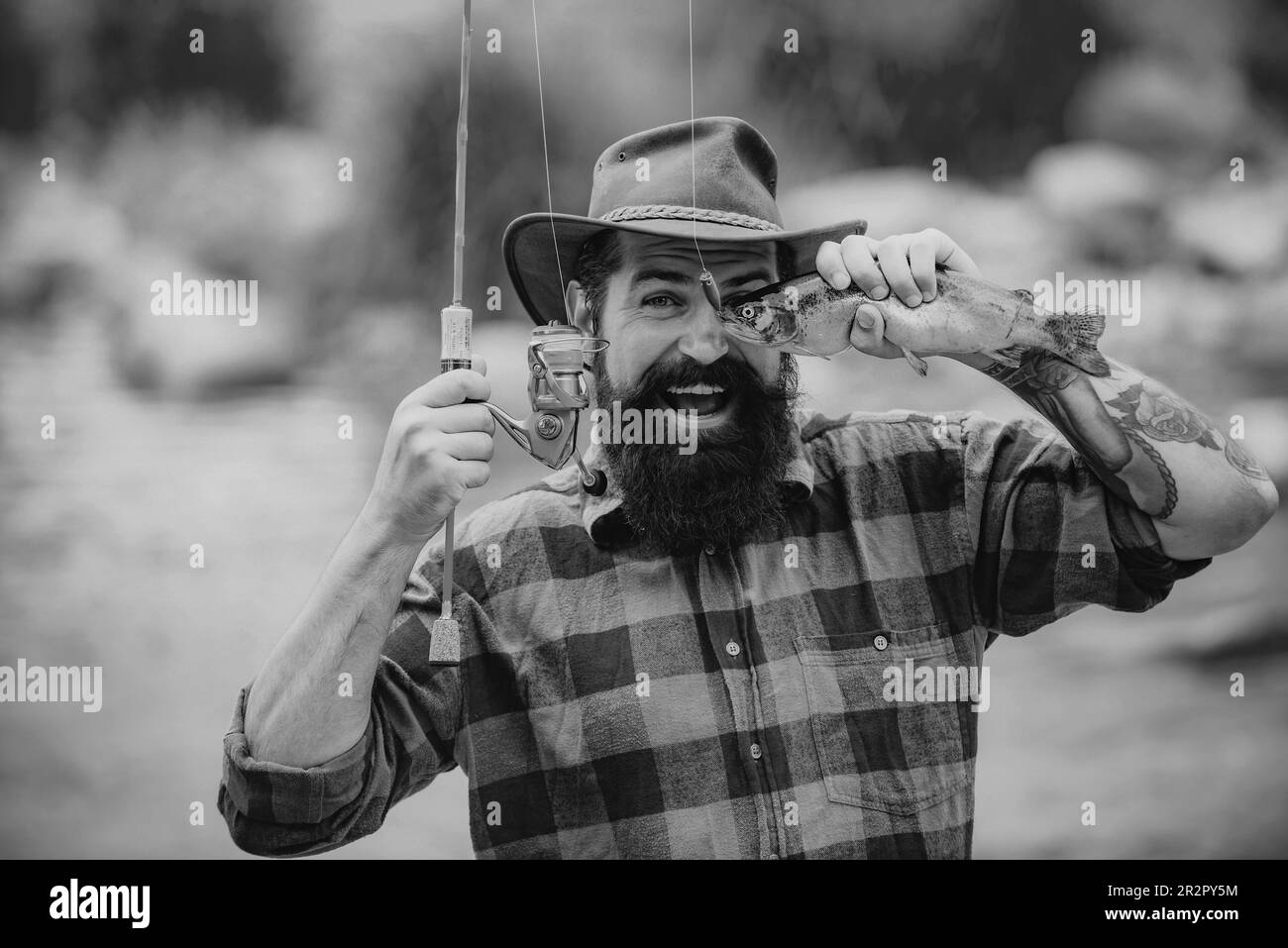 Catches a fish. Fishes catching hooks. Fishing in river. Fly fishing