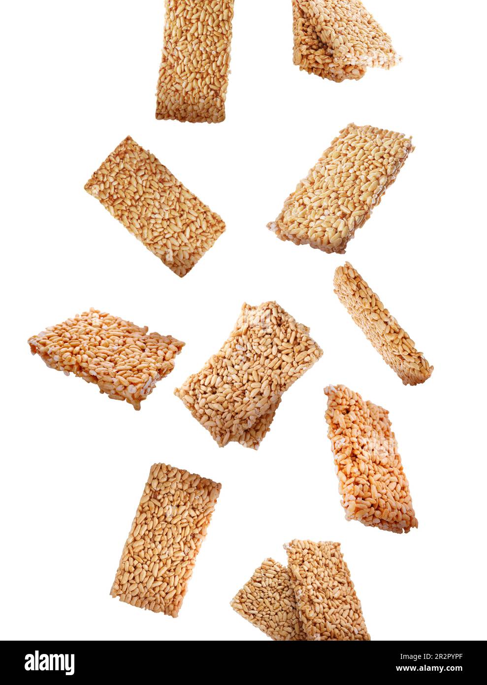 Many puffed rice bars (kozinaki) falling on white background Stock Photo
