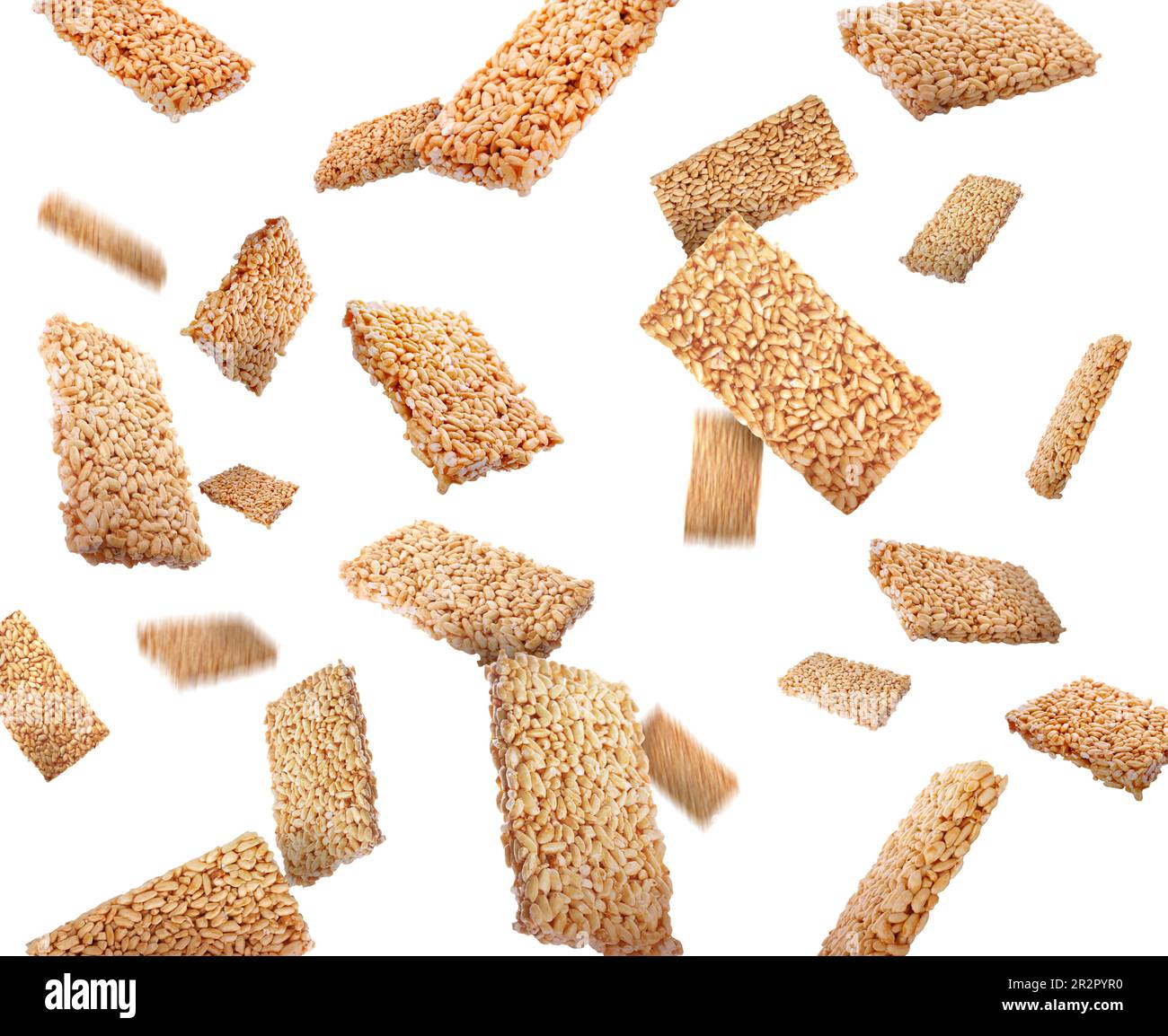 Many puffed rice bars (kozinaki) falling on white background Stock Photo