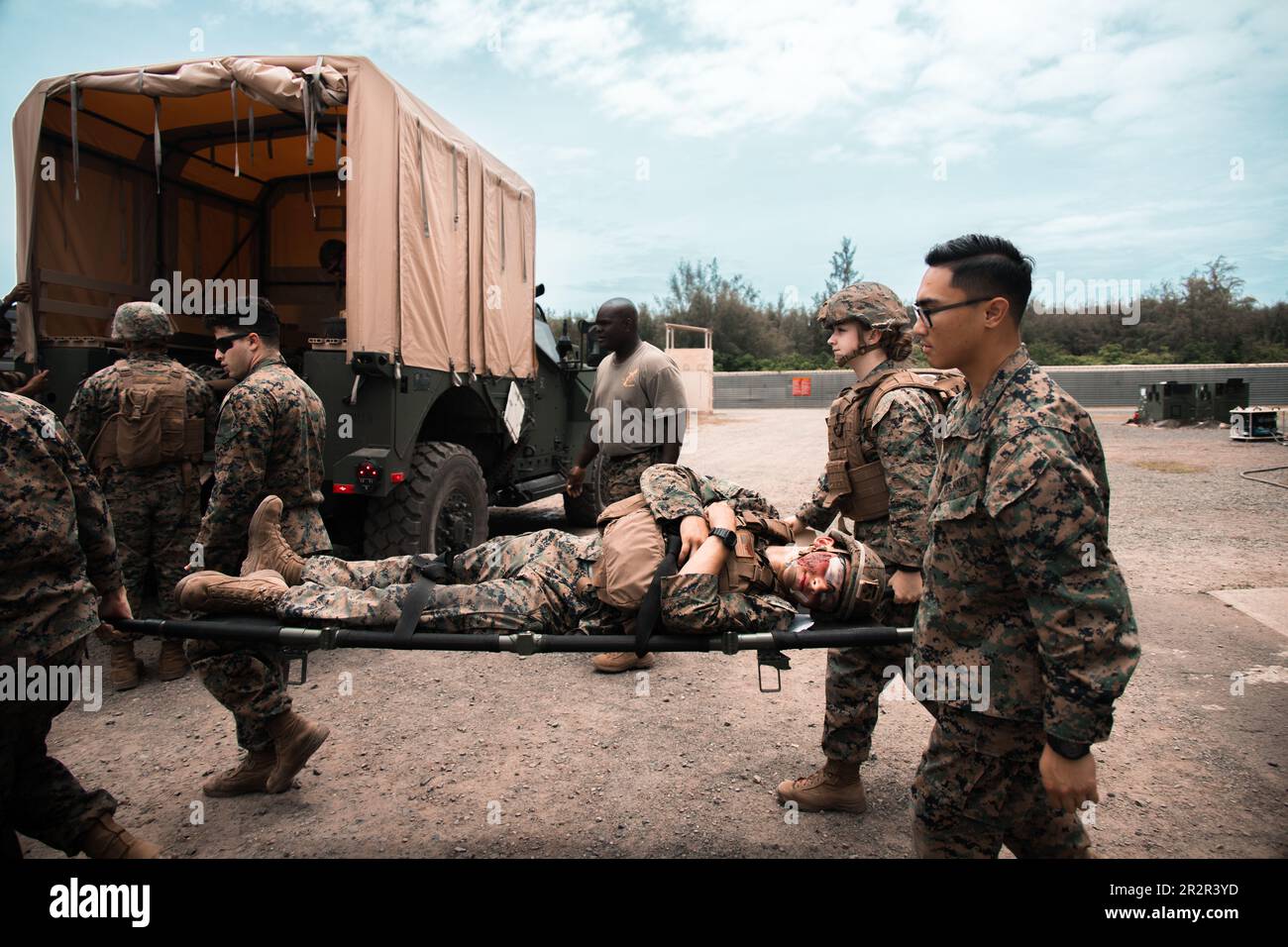 U.S. Sailors with Bravo Surgical Company, 3rd Medical Battalion, 3rd Marine Logistics Group, perform a simulated casualty evacuation at Marine Corps Training Area Bellows, Hawaii, May 17, 2023. The purpose of the exercise was to test lower level medical capabilities and increase medical readiness by providing care in the air and on the ground during evacuations to higher echelons of care. (U.S. Marine Corps photo by Cpl. Christian Tofteroo) Stock Photo