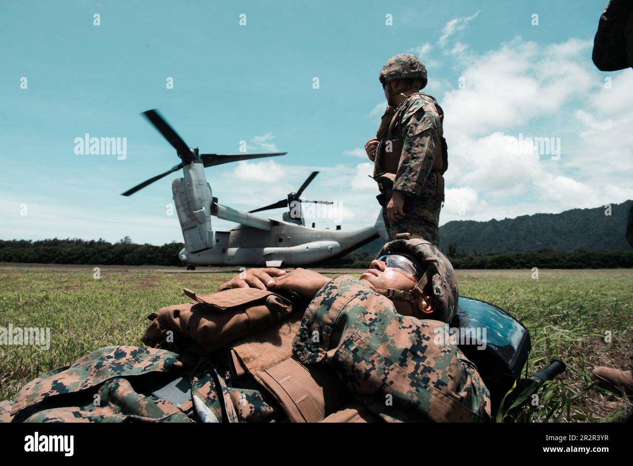 U.S. Sailors with Bravo Surgical Company, 3rd Medical Battalion, 3rd Marine Logistics Group, perform a simulated casualty evacuation at Marine Corps Training Area Bellows, Hawaii, May 17, 2023. The purpose of the exercise was to test lower level medical capabilities and increase medical readiness by providing care in the air and on the ground during evacuations to higher echelons of care. (U.S. Marine Corps photo by Cpl. Christian Tofteroo) Stock Photo
