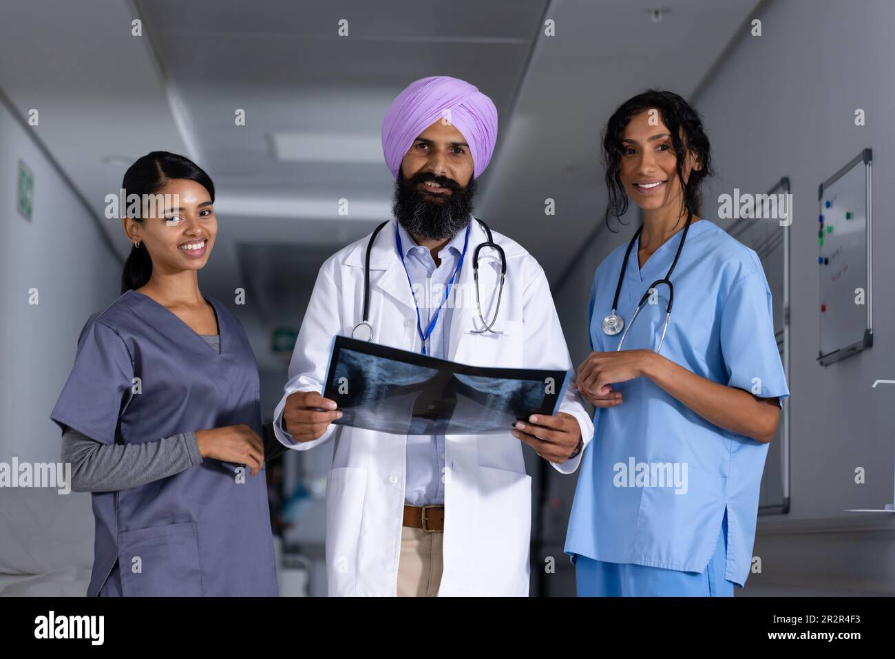 Portrait of diverse male and female doctors holding x-ray scan and ...
