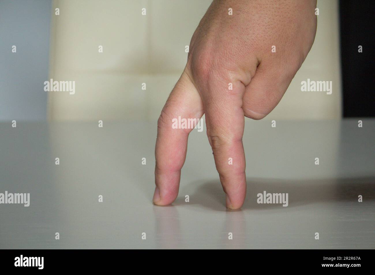 Image of the fingers of a hand imitating a person's walk. Stock Photo