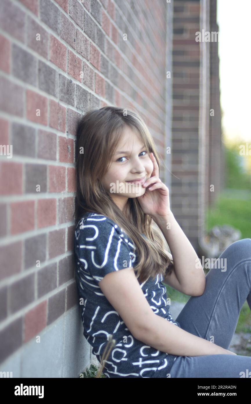 Beautiful young long hair girl in causal clothes posing outdoors Stock Photo