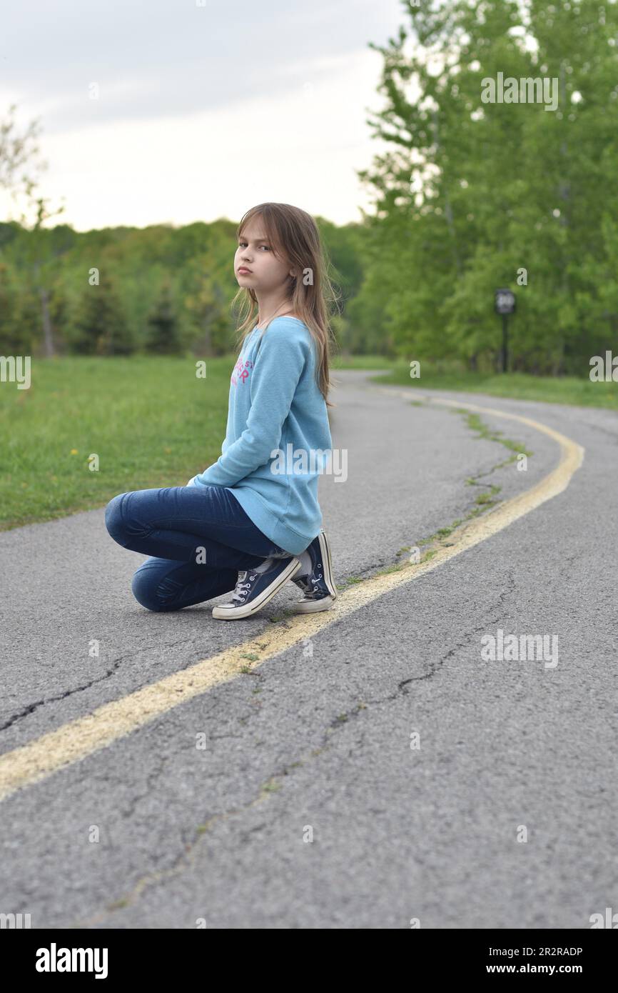 Beautiful young long hair girl in causal clothes posing outdoors Stock Photo