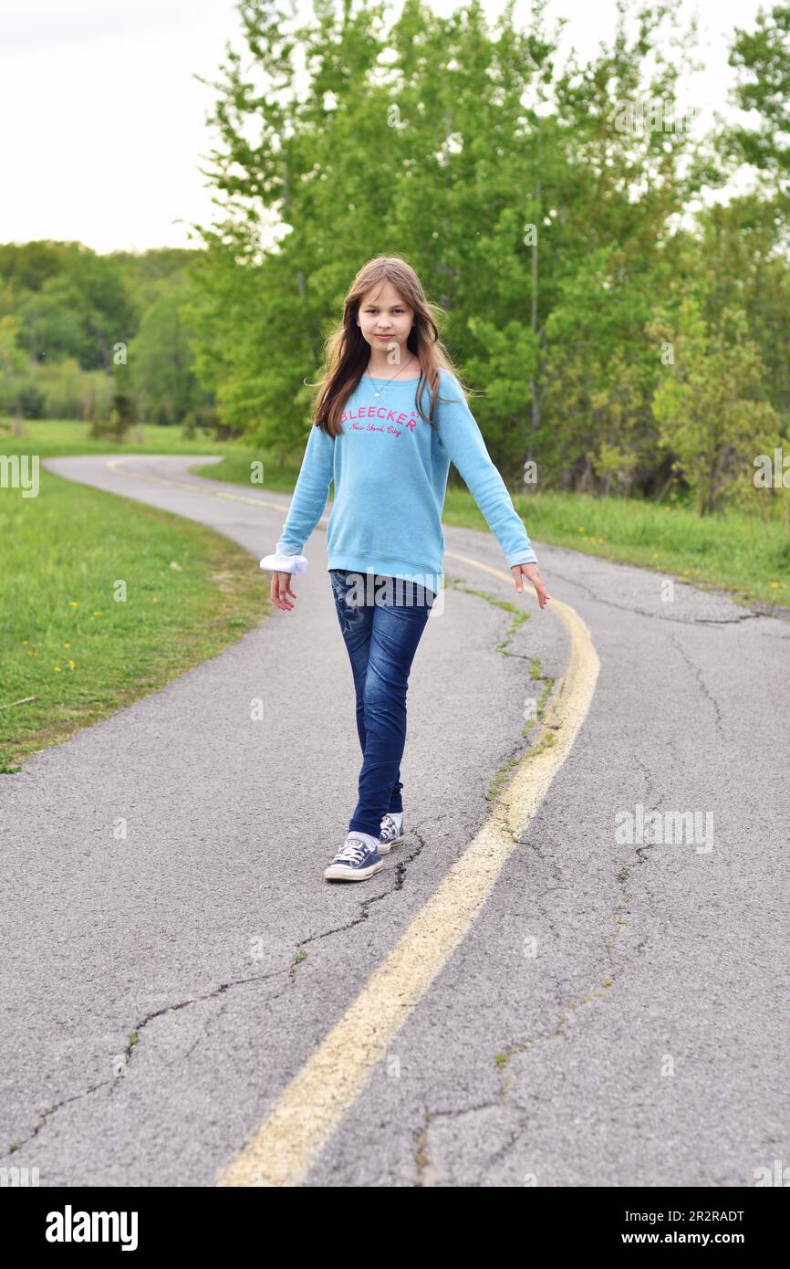 Beautiful young long hair girl in causal clothes posing outdoors Stock Photo