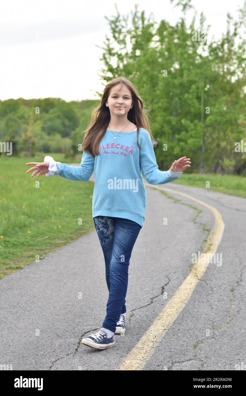 Beautiful young long hair girl in causal clothes posing outdoors Stock Photo