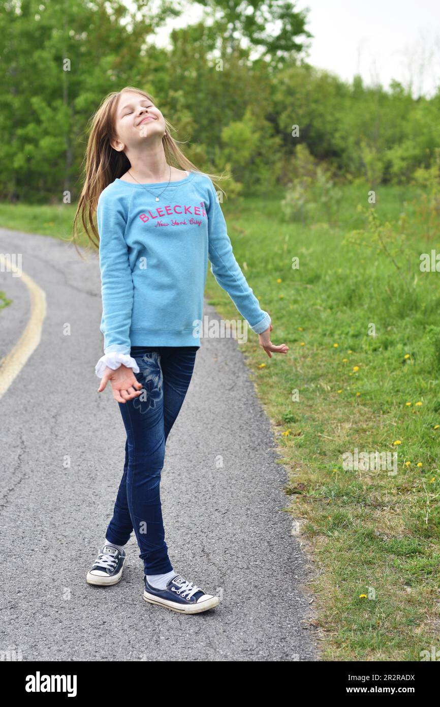 Beautiful young long hair girl in causal clothes posing outdoors Stock Photo