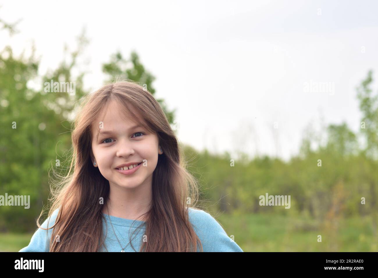 Beautiful young long hair girl in causal clothes posing outdoors Stock Photo