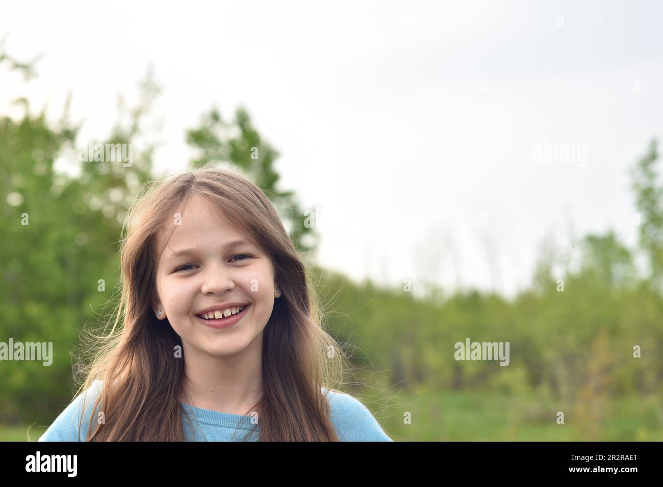 Beautiful young long hair girl in causal clothes posing outdoors Stock Photo