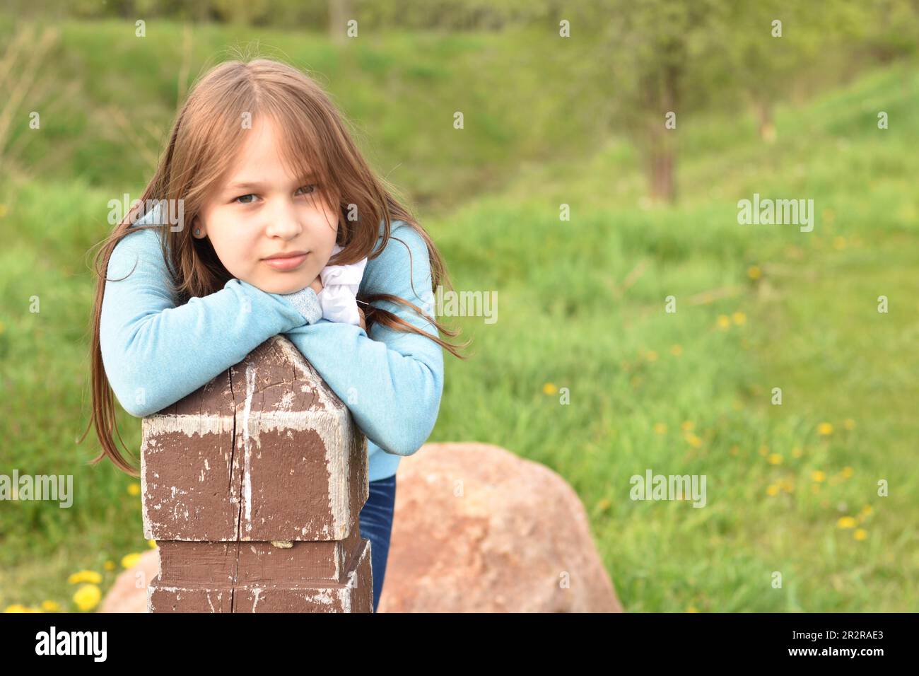 Beautiful young long hair girl in causal clothes posing outdoors Stock Photo