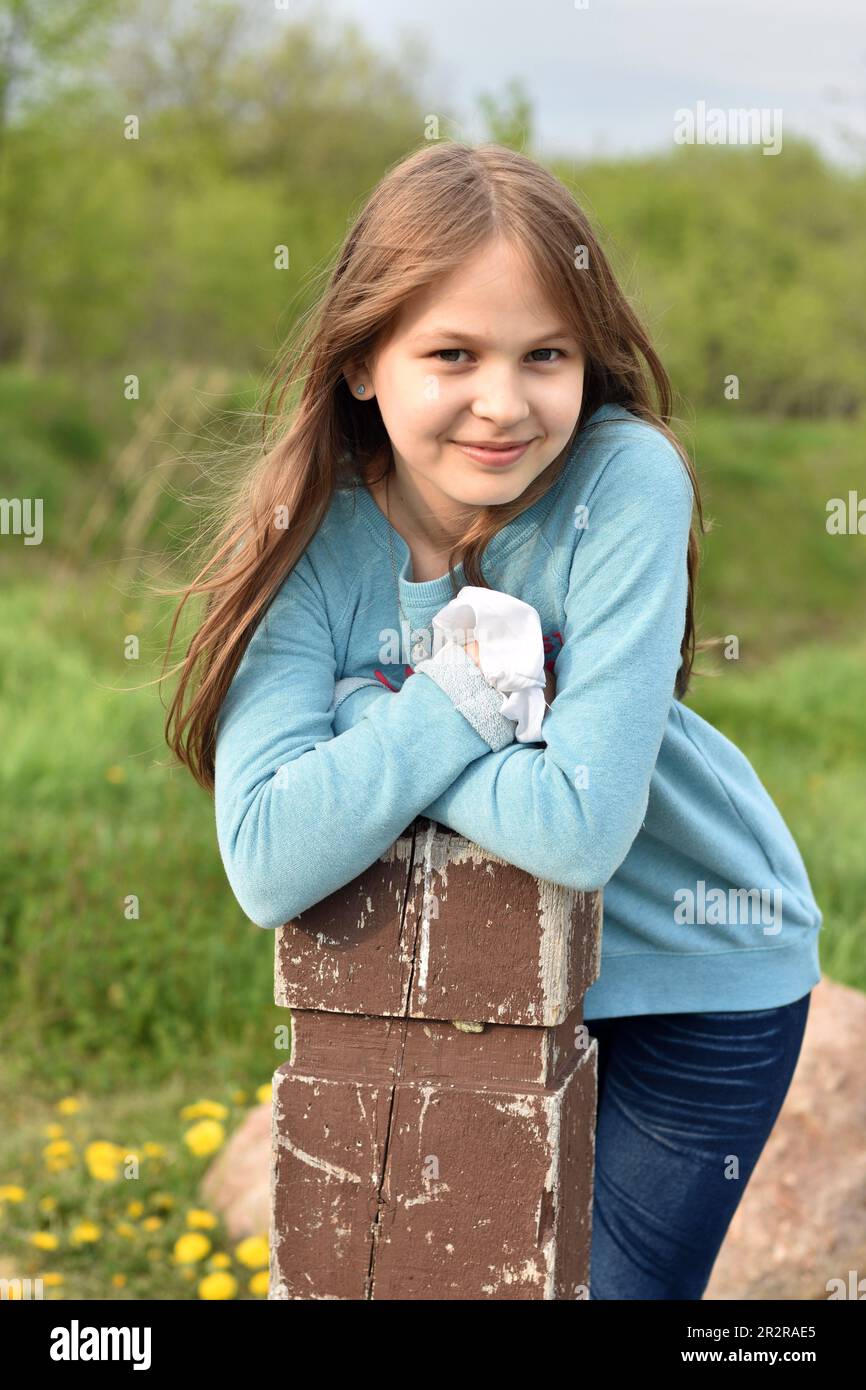 Beautiful young long hair girl in causal clothes posing outdoors Stock Photo