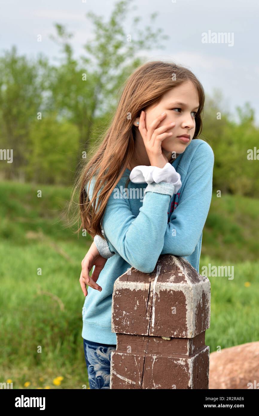 Beautiful young long hair girl in causal clothes posing outdoors Stock Photo